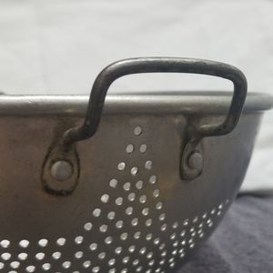 Vintage metal colainder with a star pattern